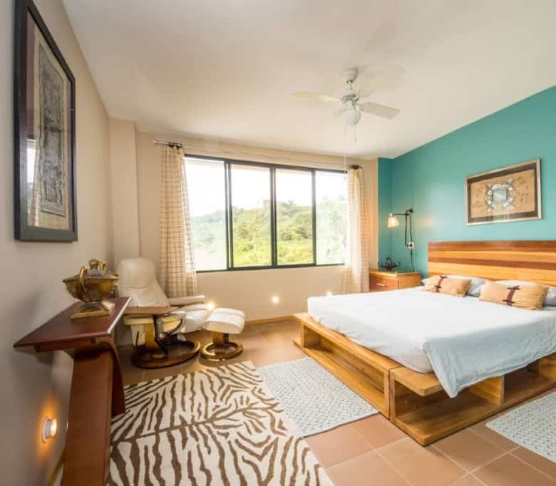 Bright bedroom with river views in Llurimagua, Ecuador.