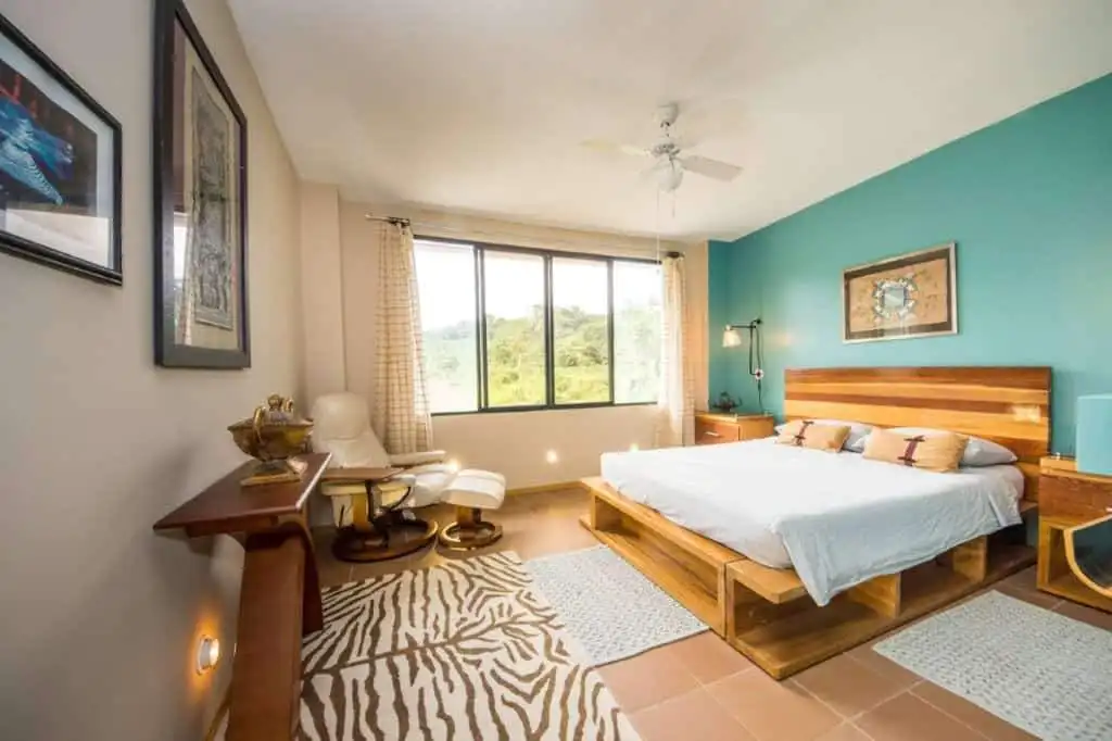 Bright bedroom with river views in Llurimagua, Ecuador.