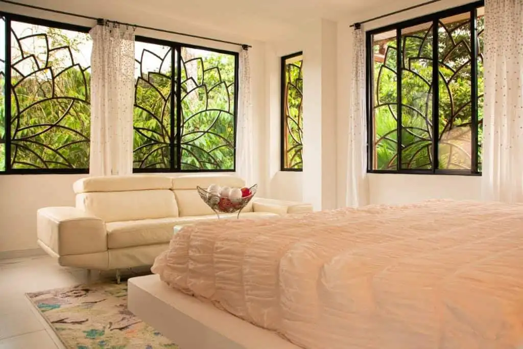 View bedroom with large windows and natural light.