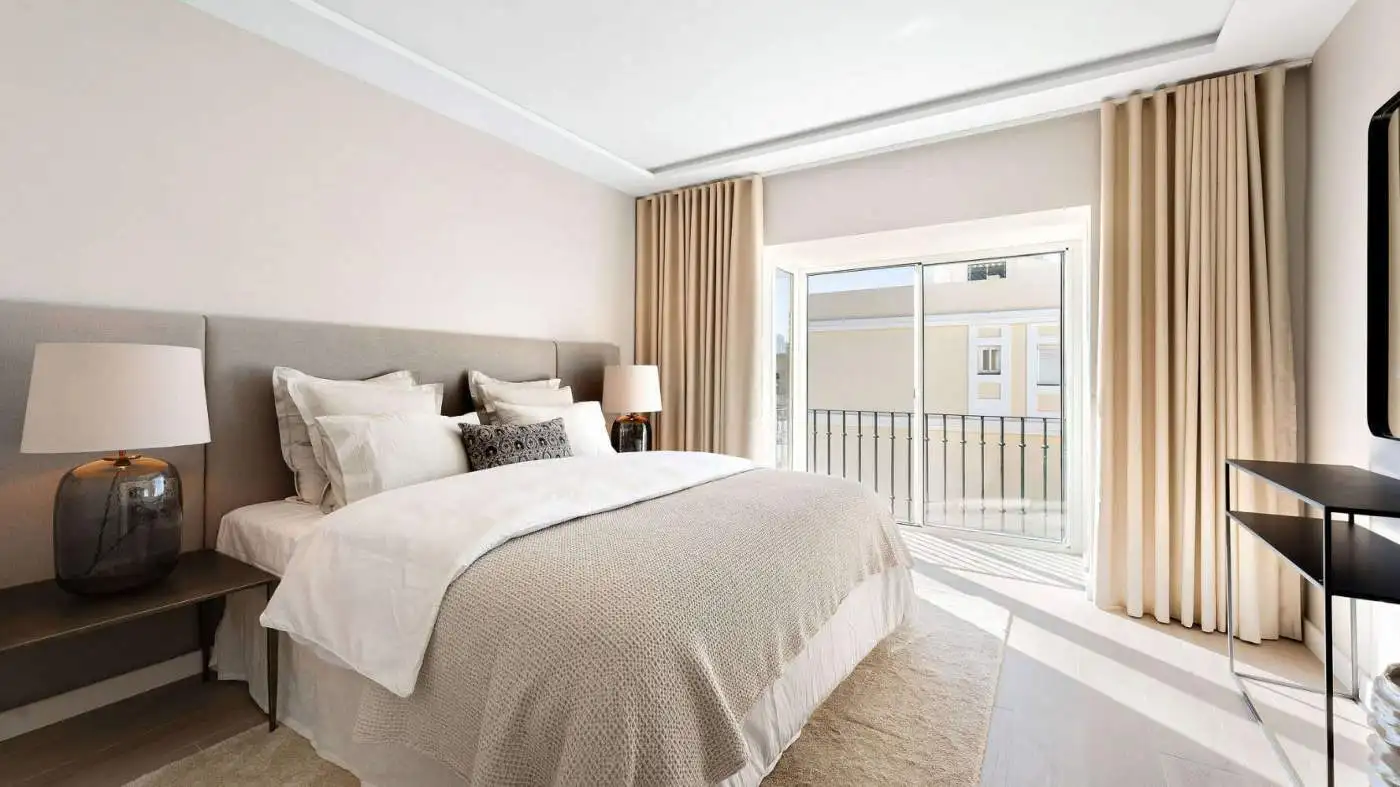 Bright bedroom with panoramic city views from the duplex penthouse balcony.