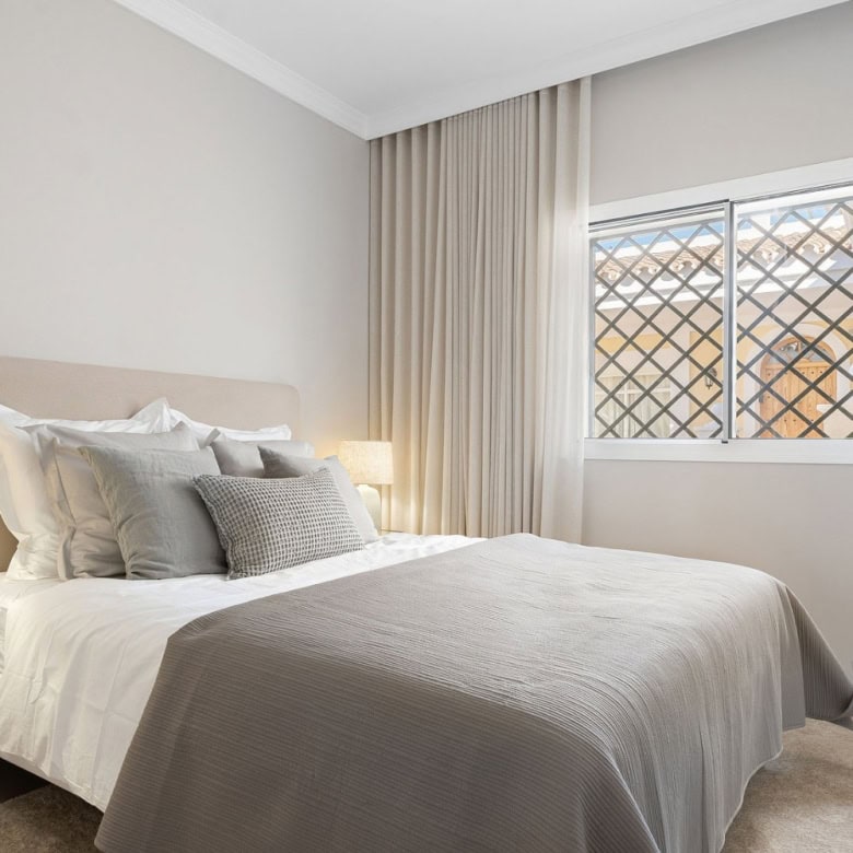Bright bedroom in Aloha Gardens panoramic duplex penthouse with modern decor.