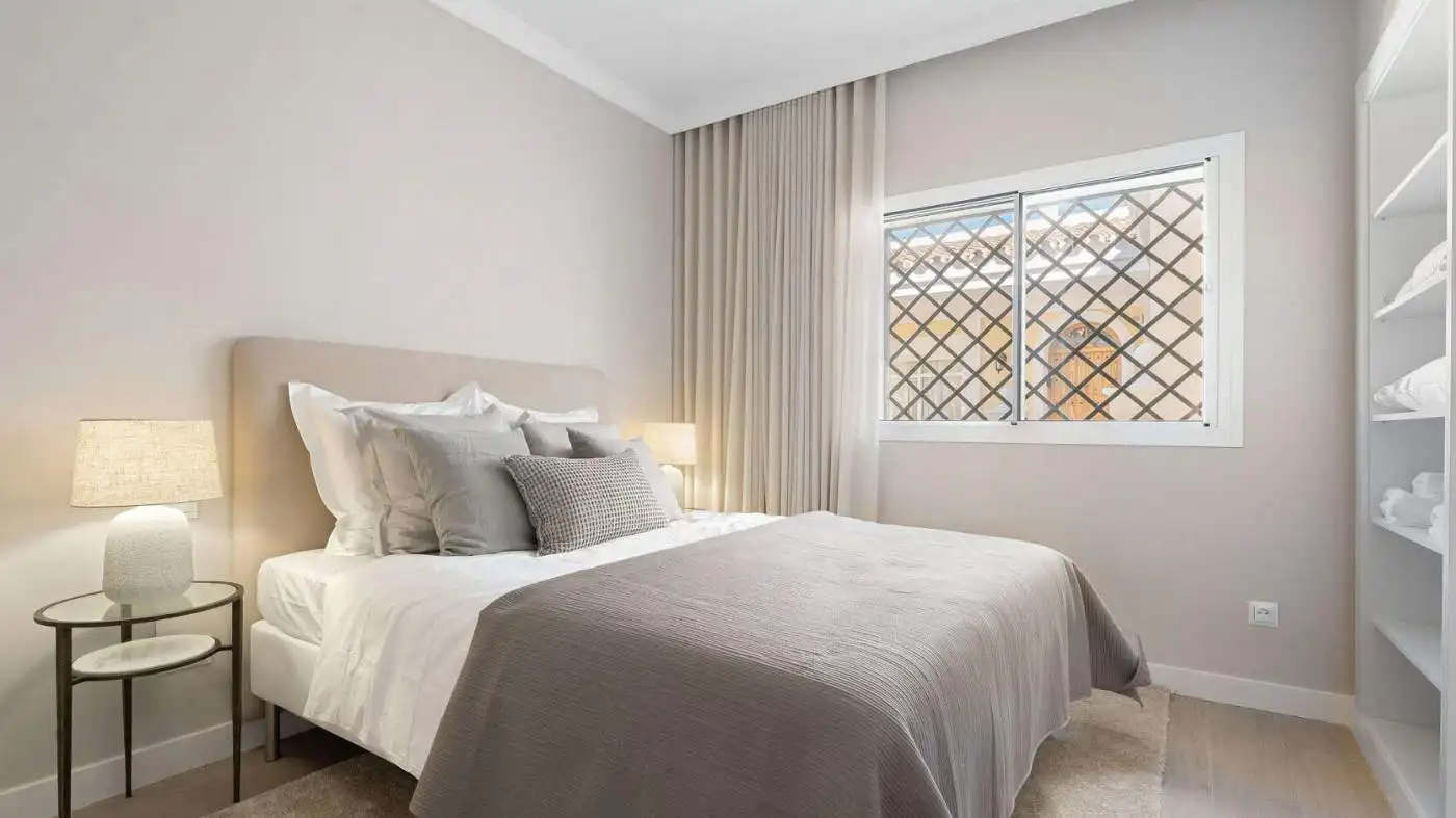 Bright bedroom in Aloha Gardens panoramic duplex penthouse with modern decor.