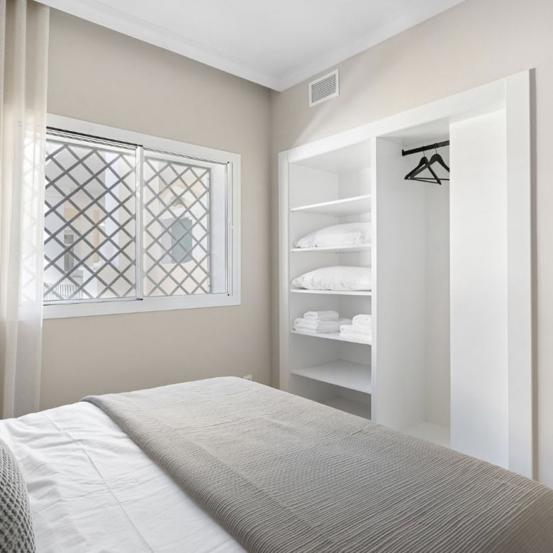 Panoramic duplex penthouse bedroom at Aloha Gardens with bright natural light and modern decor.
