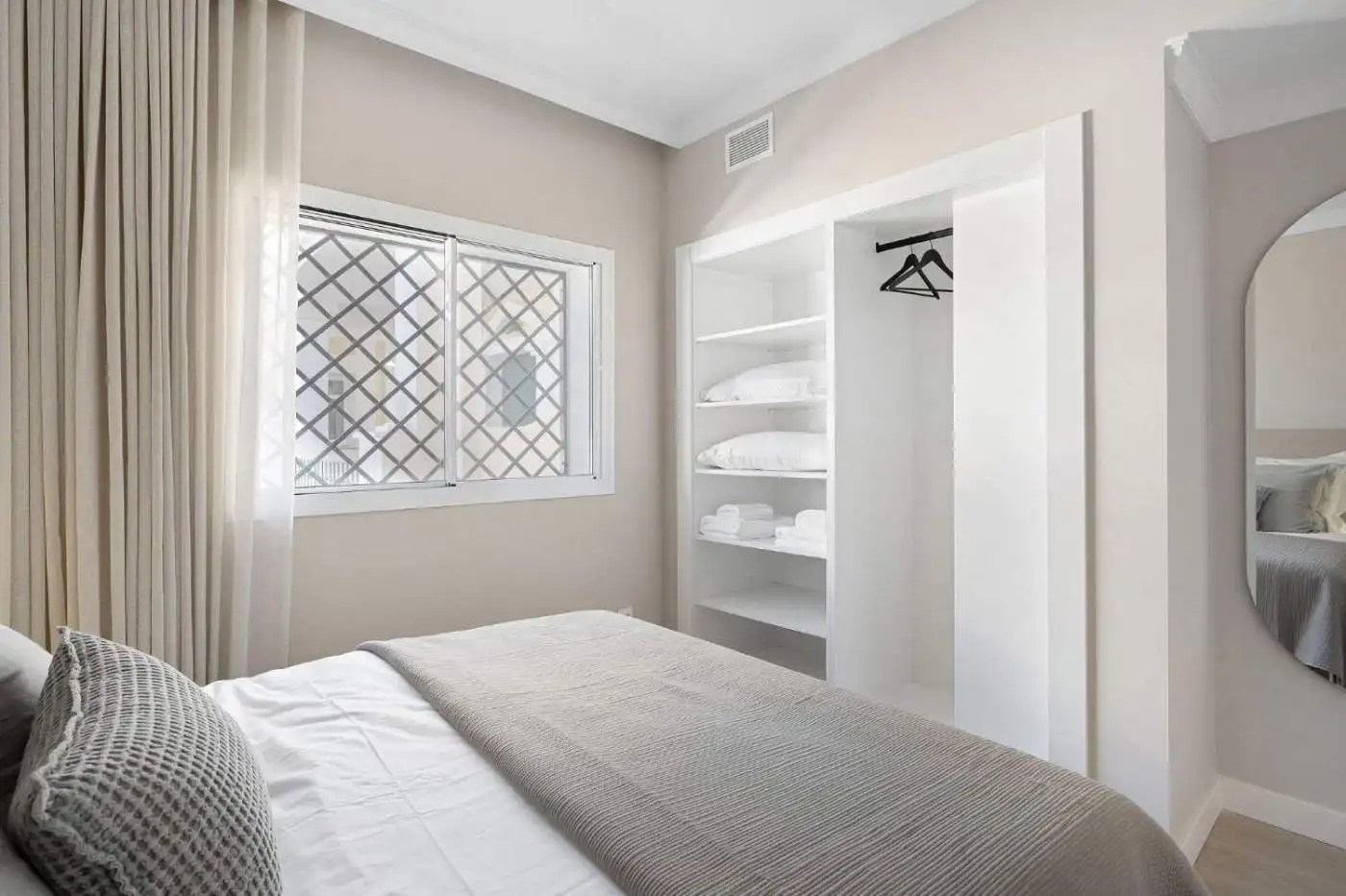 Panoramic duplex penthouse bedroom at Aloha Gardens with bright natural light and modern decor.