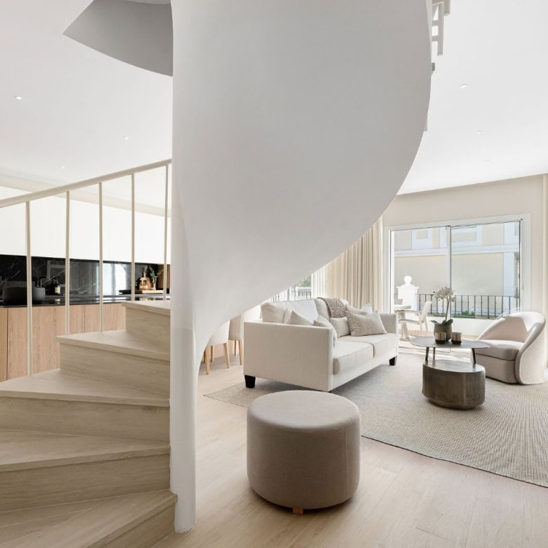 Spacious living area in Aloha Gardens duplex penthouse with large windows and elegant furniture.