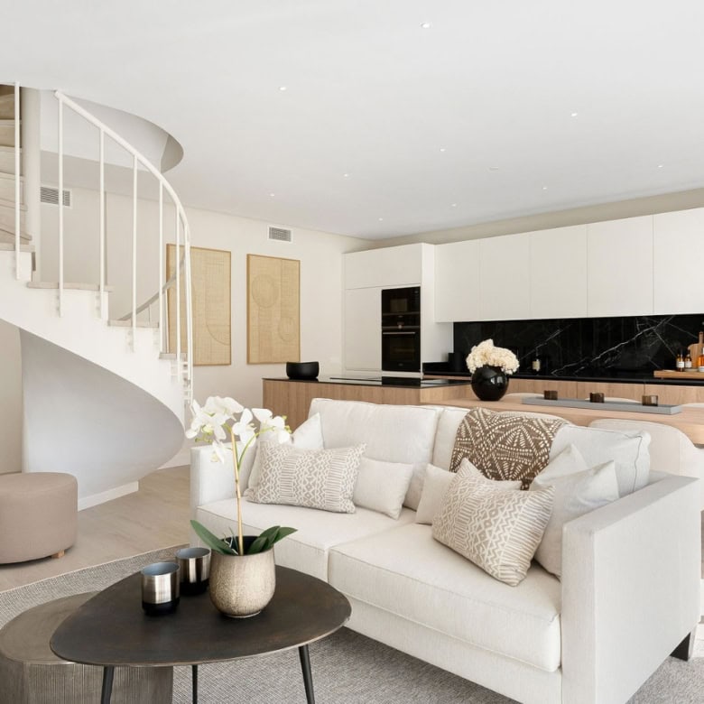 Elegant duplex penthouse living room with modern decor and open-plan design.