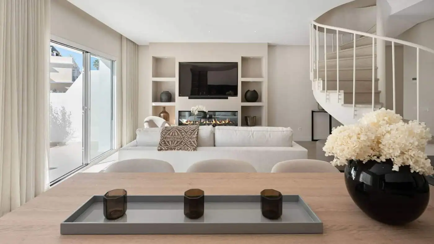 Modern duplex penthouse living room with panoramic views and stylish decor.