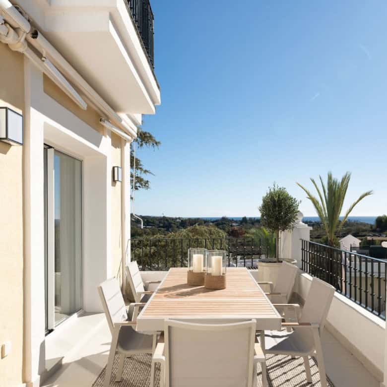 Panoramic duplex penthouse terrace with outdoor dining and scenic views.