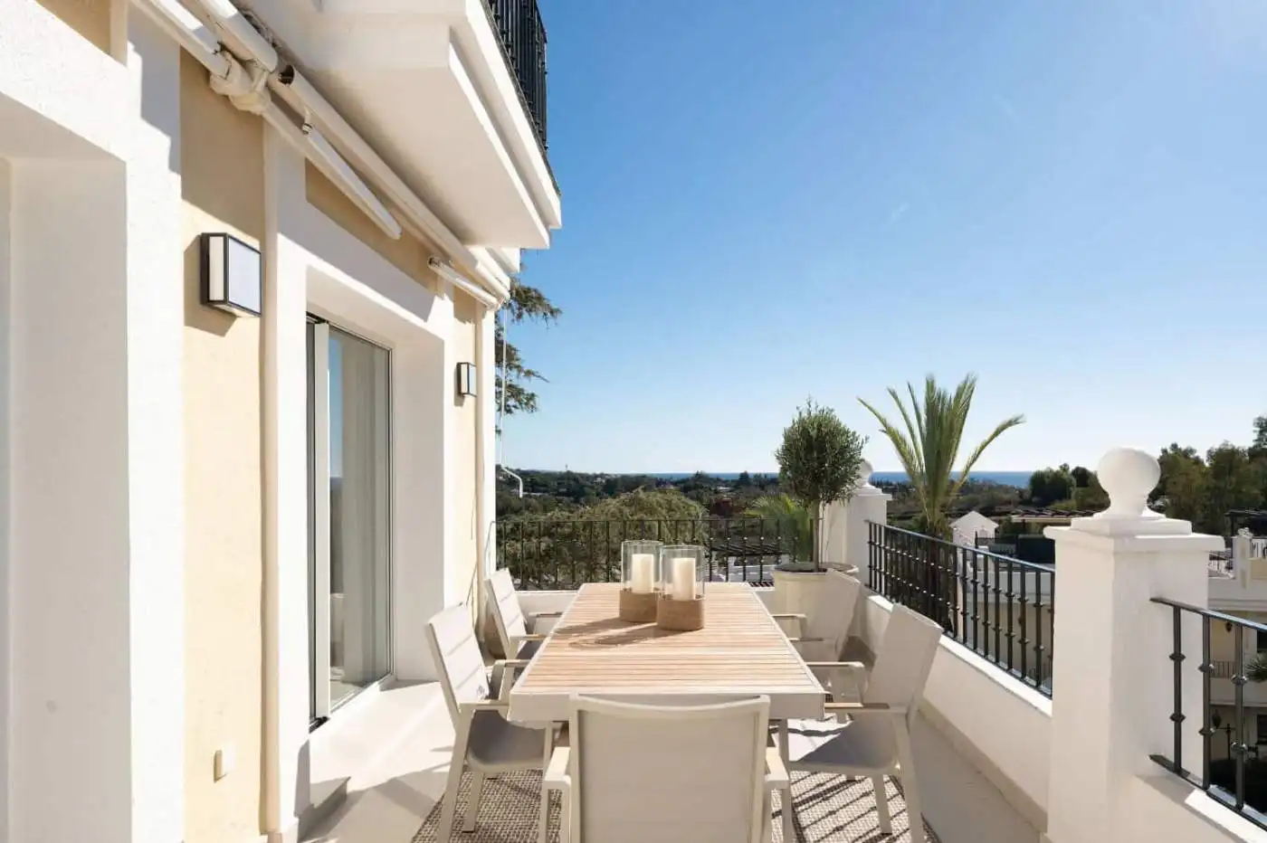 Panoramic duplex penthouse terrace with outdoor dining and scenic views.