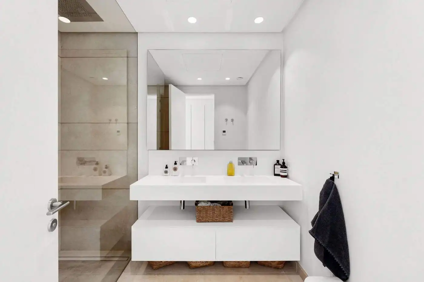 Modern bathroom with sleek white vanity, large mirror, and contemporary fixtures in Marbella duplex.