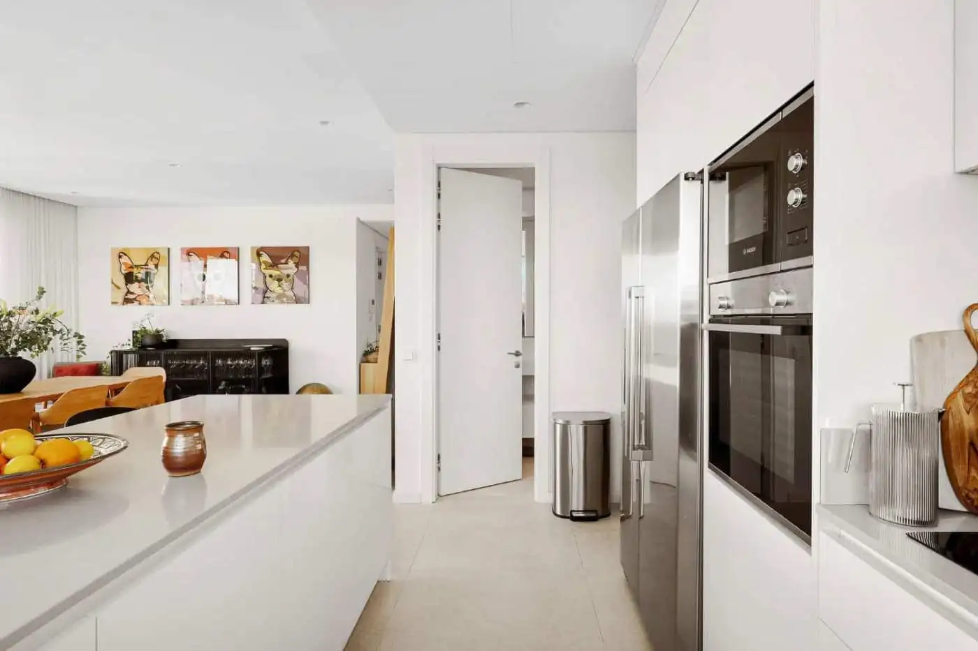Bright, contemporary kitchen featuring white cabinets, built-in oven, and sea views in Marbella.