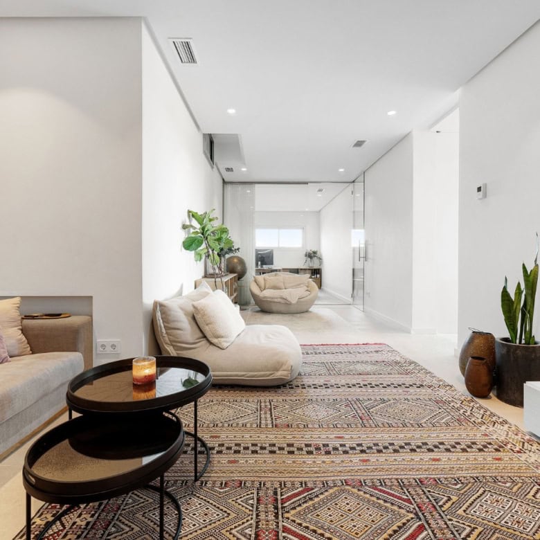 Spacious interior featuring comfortable sofas, stylish decor, and natural light.