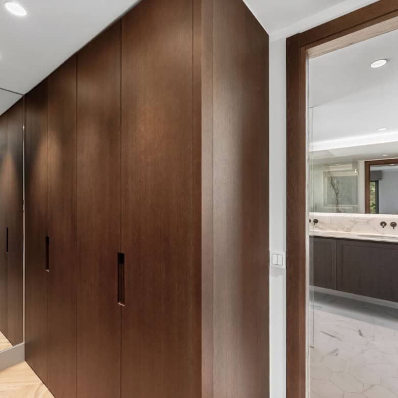 Modern wooden wardrobe in a stylish apartment hallway.
