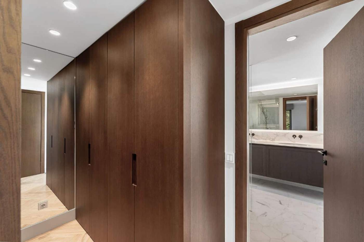 Modern wooden wardrobe in a stylish apartment hallway.