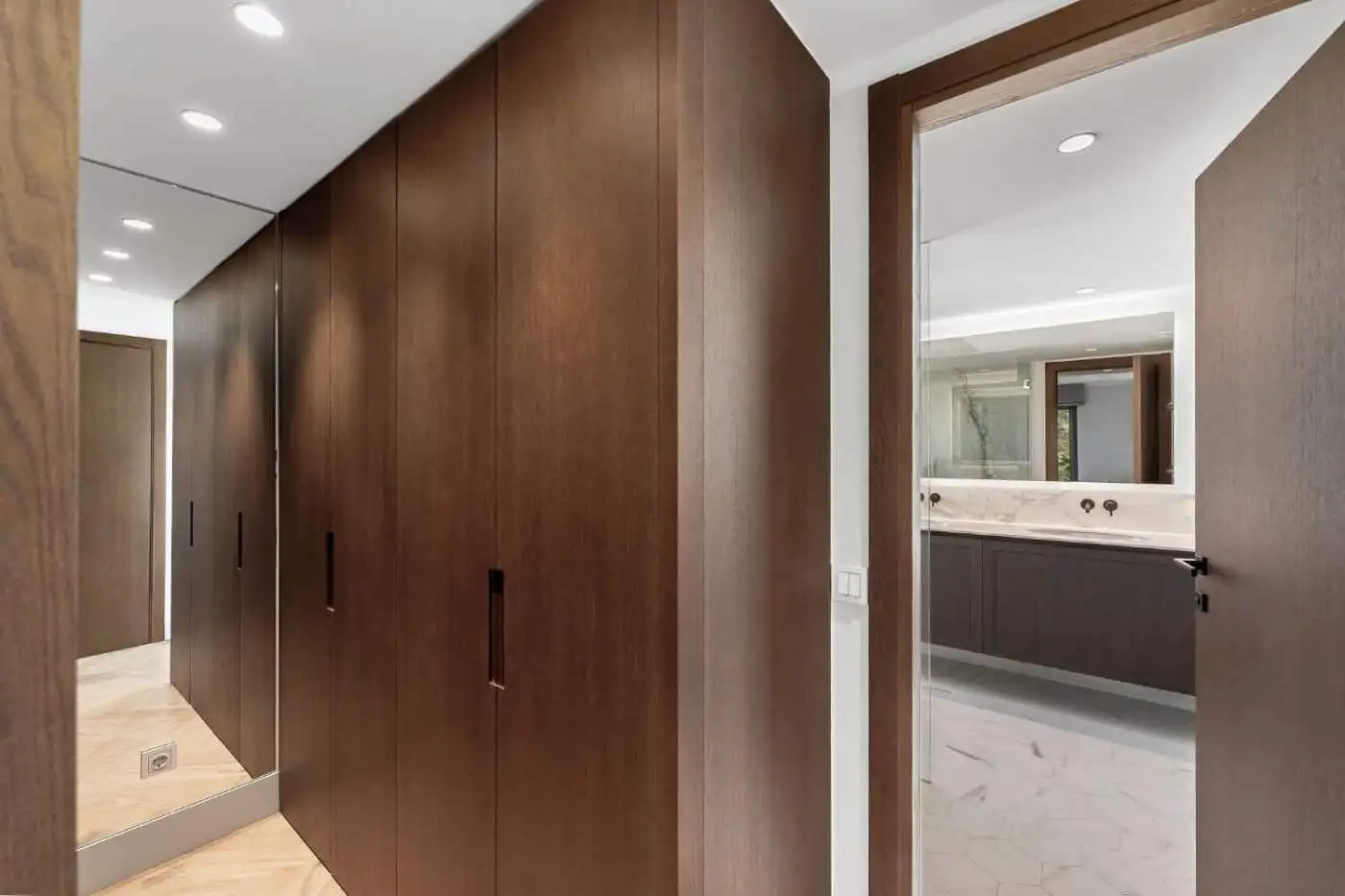 Modern wooden wardrobe in a stylish apartment hallway.