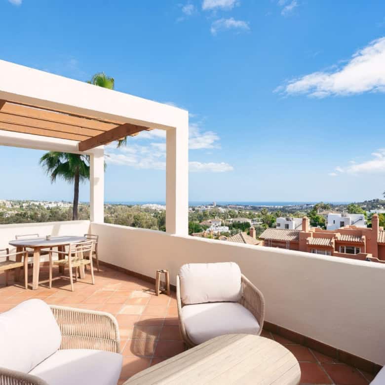 Terrace with outdoor seating and stunning city and sea views in Nueva Andalucia.