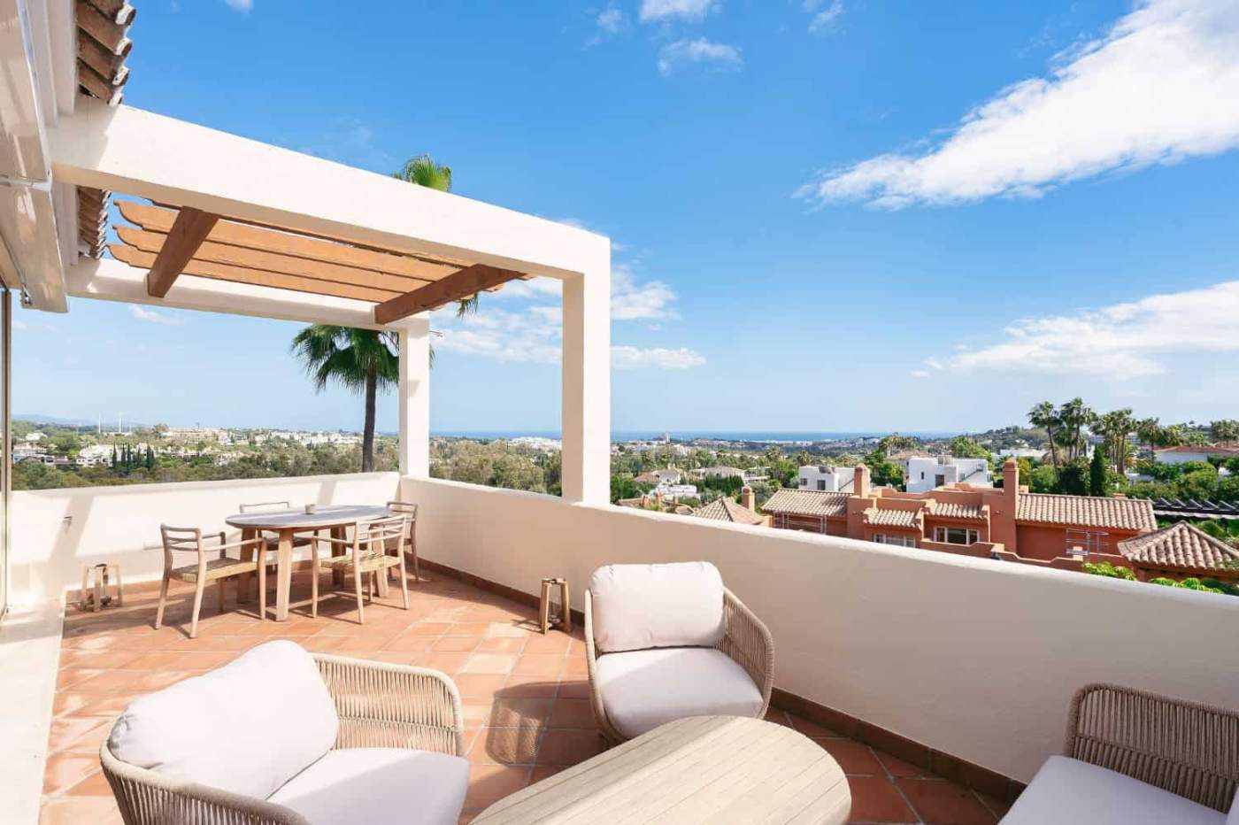 Terrace with outdoor seating and stunning city and sea views in Nueva Andalucia.