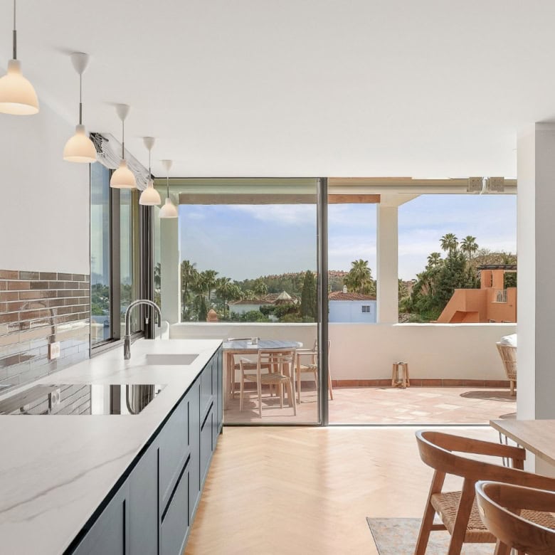 Spacious loft apartment featuring large windows and a balcony with panoramic views in Palacetes Les.