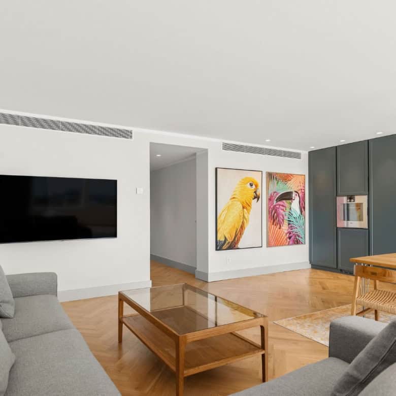 Spacious loft apartment featuring contemporary decor and colorful bird paintings in Palacetes Les Be.