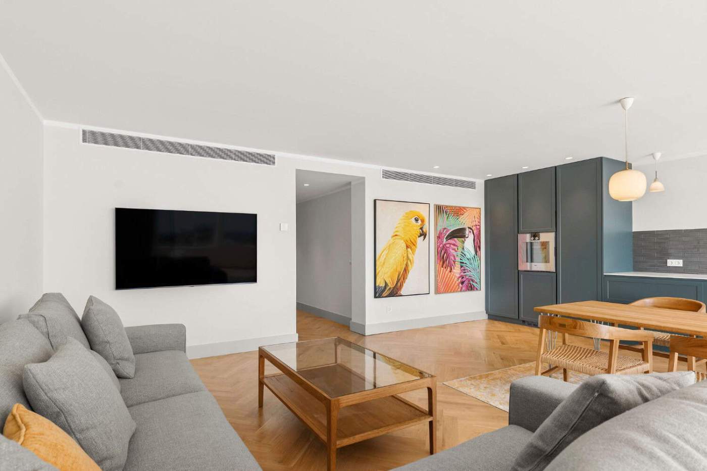 Spacious loft apartment featuring contemporary decor and colorful bird paintings in Palacetes Les Be.