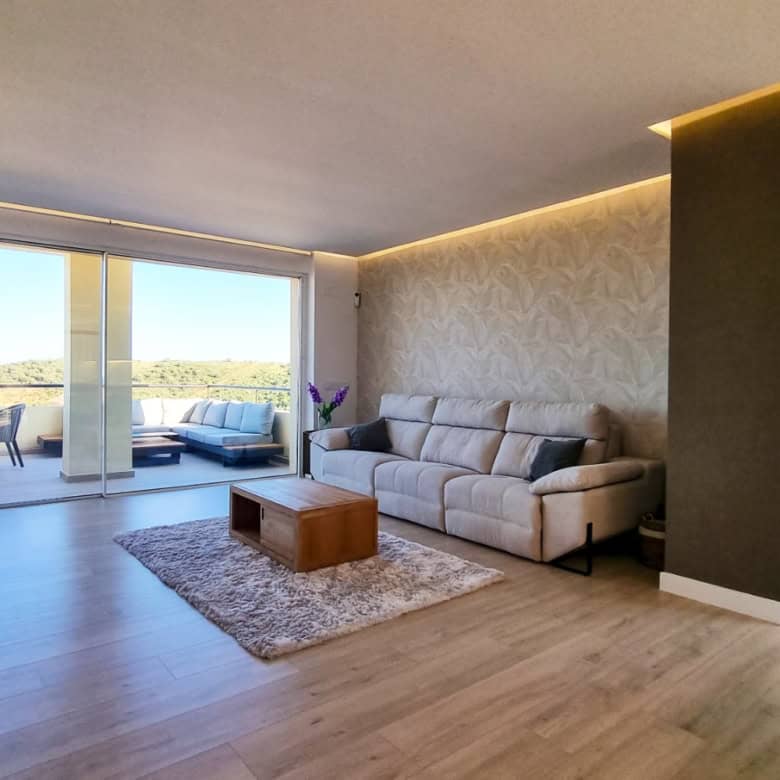 Modern living room with panoramic sea views and stylish decor in San Roque Club penthouse.
