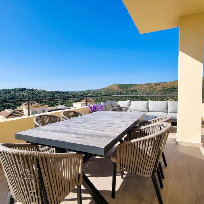 Spacious terrace of luxury penthouse overlooking the sea and surrounding landscape.