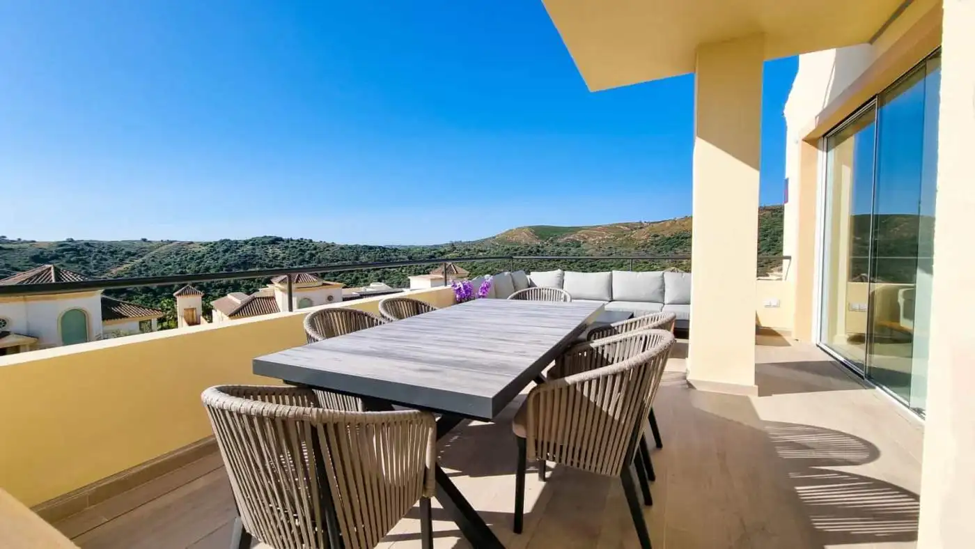 Spacious terrace of luxury penthouse overlooking the sea and surrounding landscape.