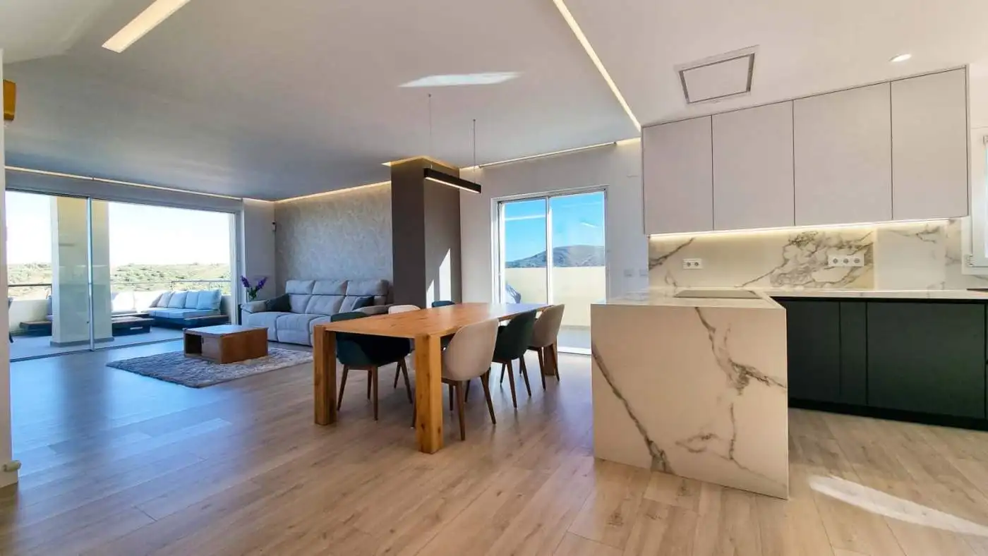 Elegant fully renovated penthouse showcasing panoramic sea views in San Roque Club. Modern interior.