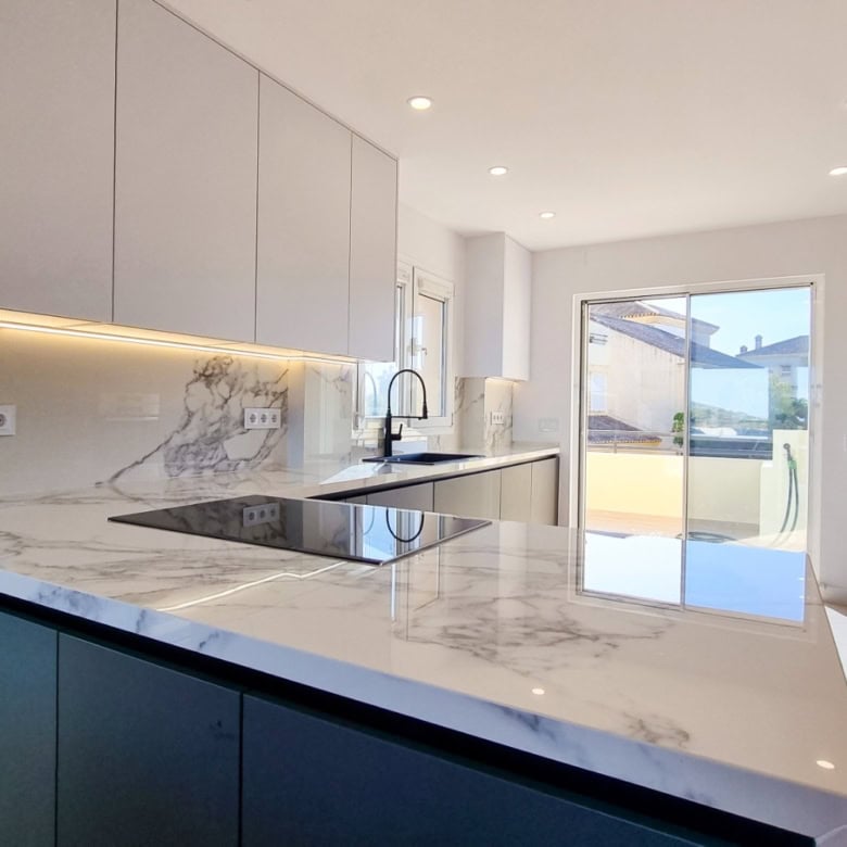 Contemporary kitchen in renovated penthouse with panoramic sea views in San Roque Club.