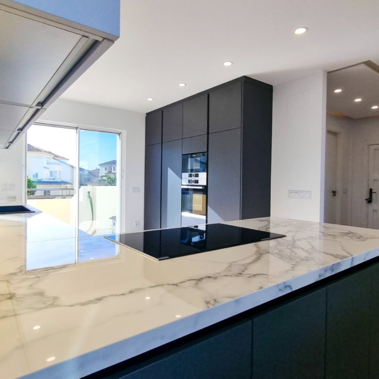 Modern fully renovated penthouse kitchen with panoramic sea views in San Roque Club. Elegant design.