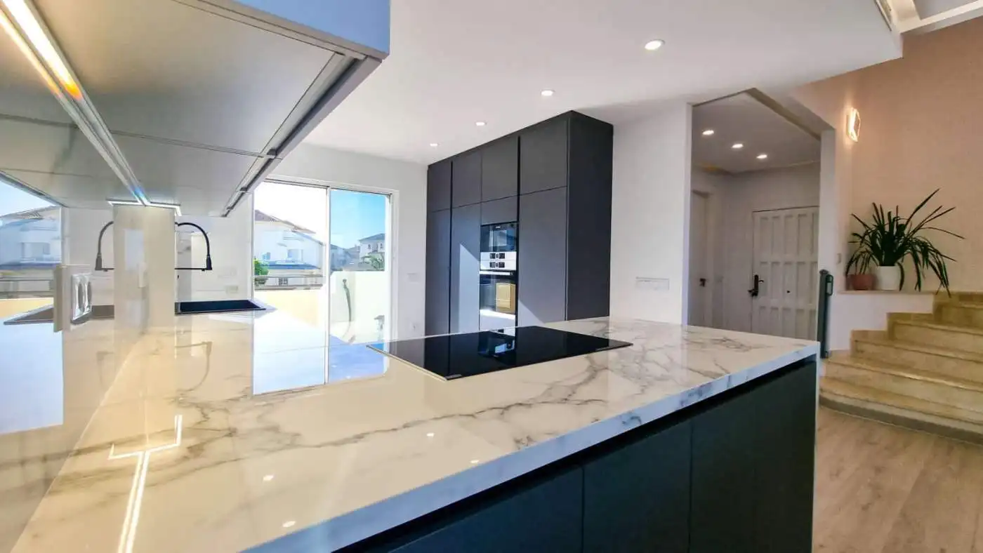 Modern fully renovated penthouse kitchen with panoramic sea views in San Roque Club. Elegant design.