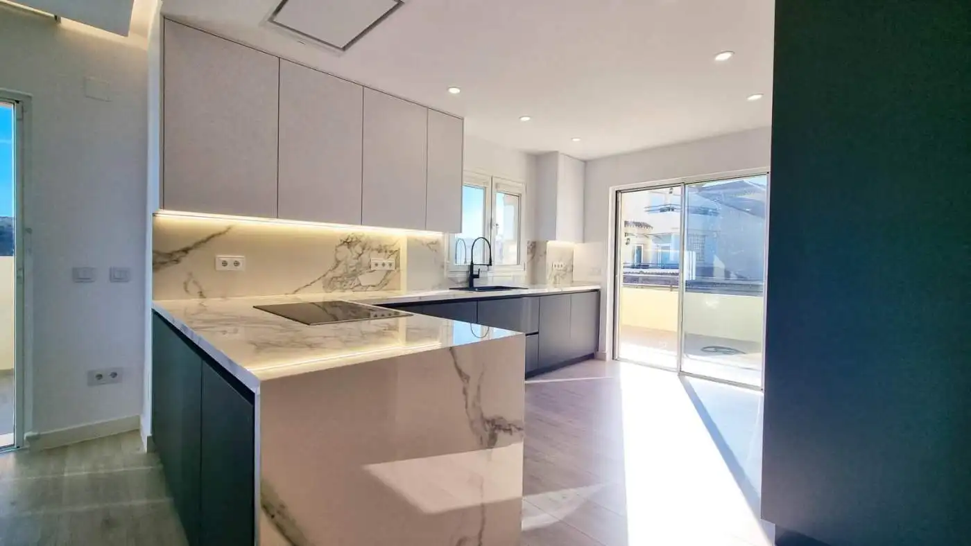 Contemporary fully renovated penthouse kitchen with panoramic sea views in San Roque Club.