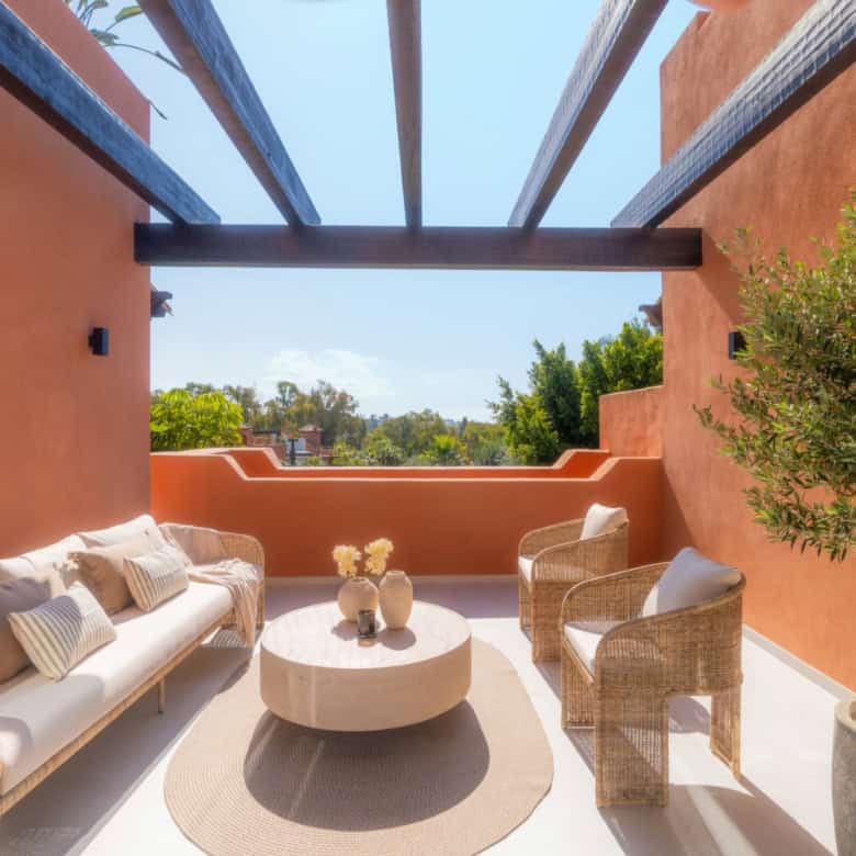 Luxurious duplex penthouse terrace in Marbella with stylish outdoor seating and panoramic views.