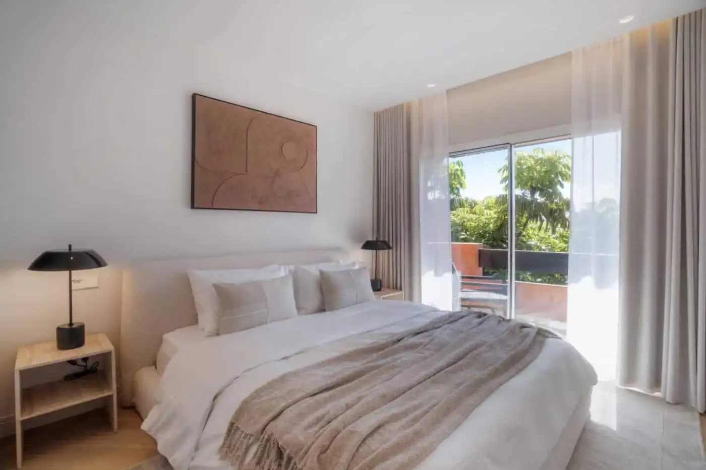 Luxurious renovated duplex penthouse bedroom in Alminar de Marbella with balcony and scenic views.