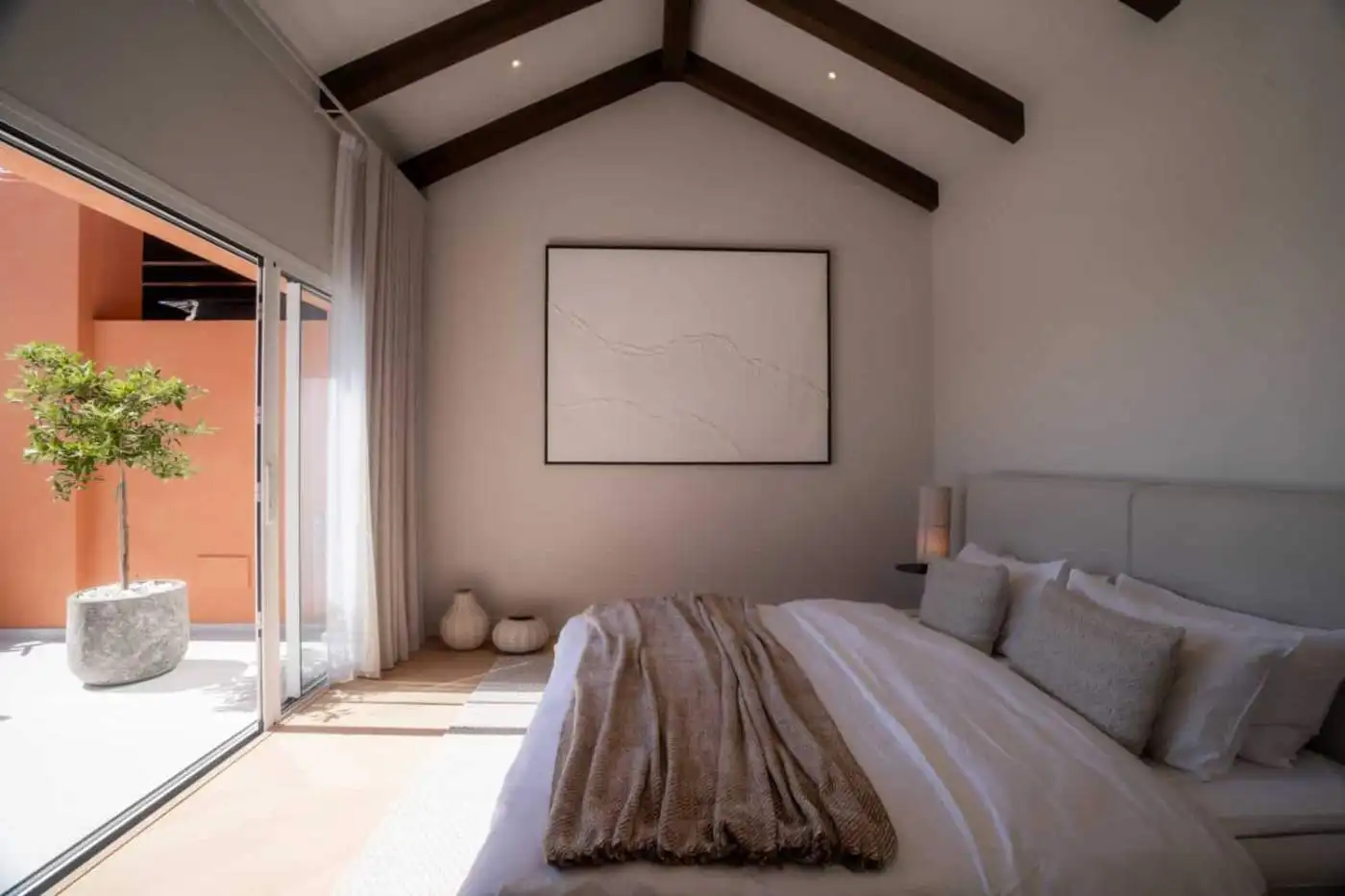 Elegant bedroom with modern decor in a renovated duplex penthouse in Marbella. Bright space with hig.