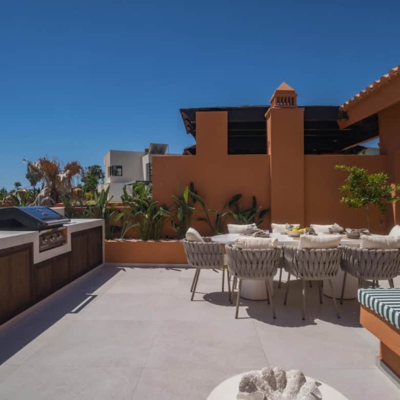 Elegant rooftop terrace with outdoor dining area in Marbella.