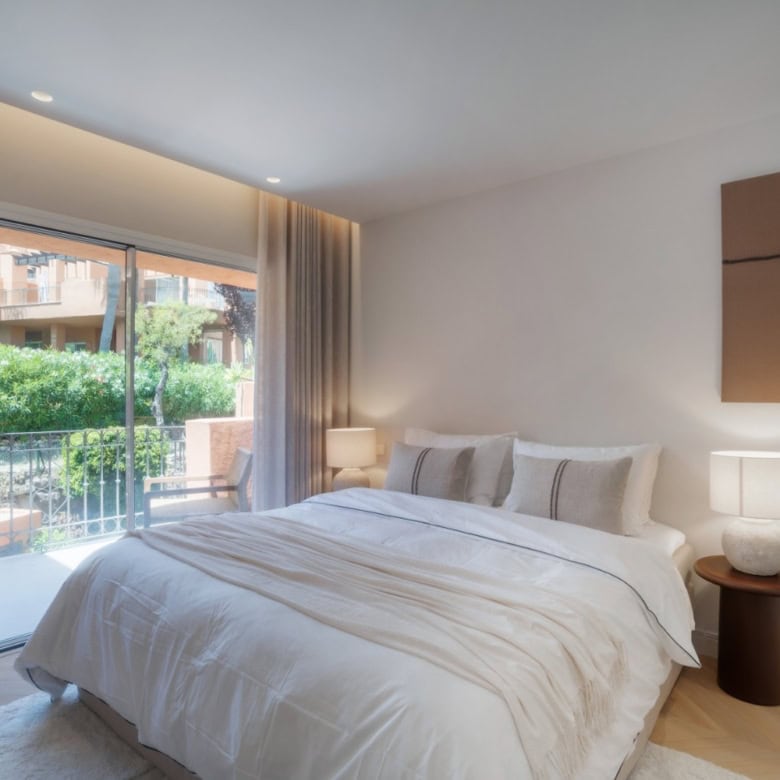 Luxurious renovated duplex penthouse bedroom in Alminar de Marbella with balcony and natural light.