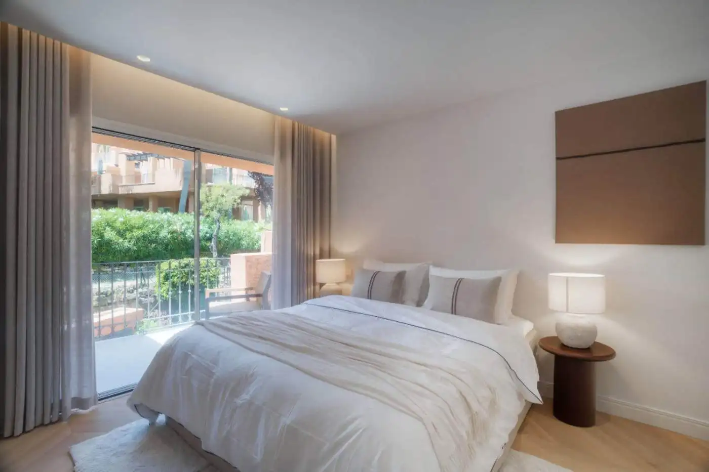 Luxurious renovated duplex penthouse bedroom in Alminar de Marbella with balcony and natural light.