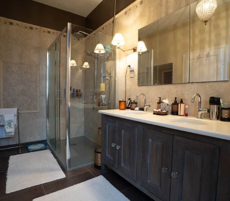 Modern bathroom with walk-in shower in a stylish French house.