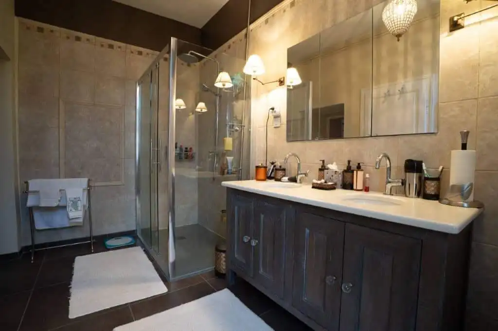 Modern bathroom with walk-in shower in a stylish French house.
