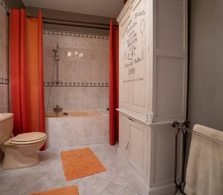 Bright bathroom with bathtub, shower, and modern fixtures in Chateaudun, France. Perfect for comfort.