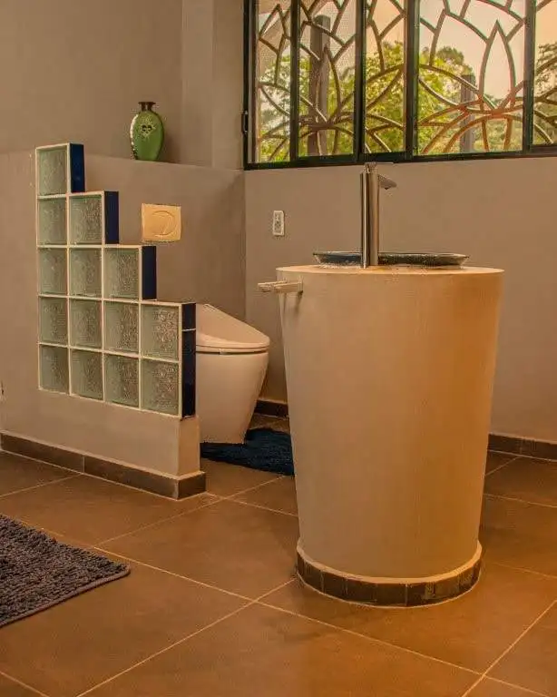 Bathroom with modern fixtures and natural light in Llurimagua Ecuador.