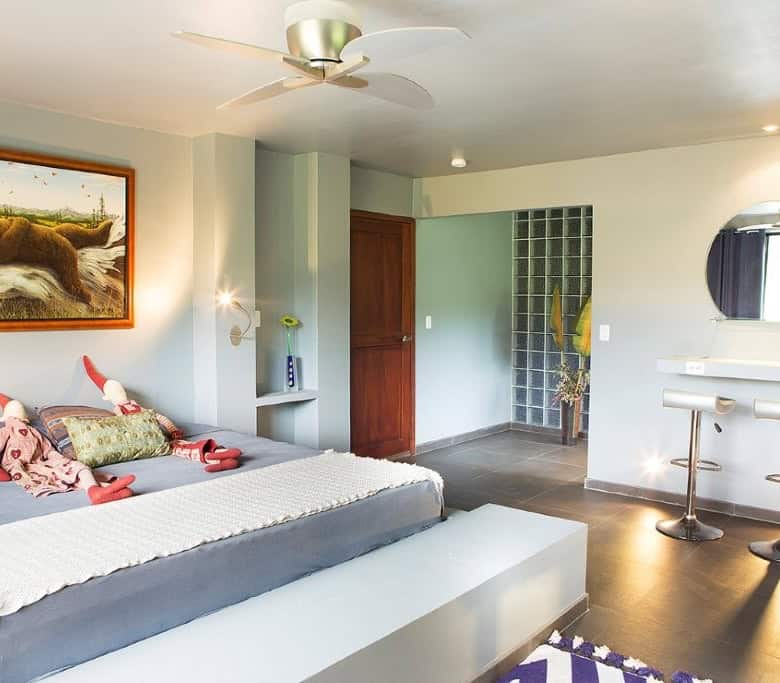 Beautiful bedroom at Flowing River Retreat in Llurimagua, Ecuador, with modern decor and natural lig.