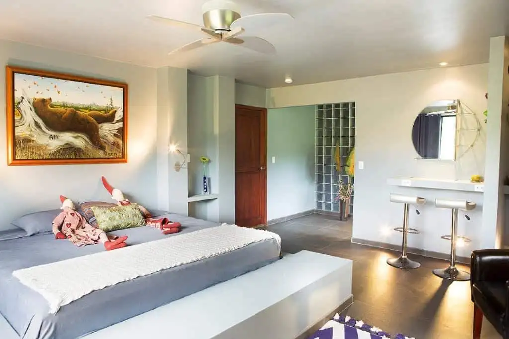 Beautiful bedroom at Flowing River Retreat in Llurimagua, Ecuador, with modern decor and natural lig.