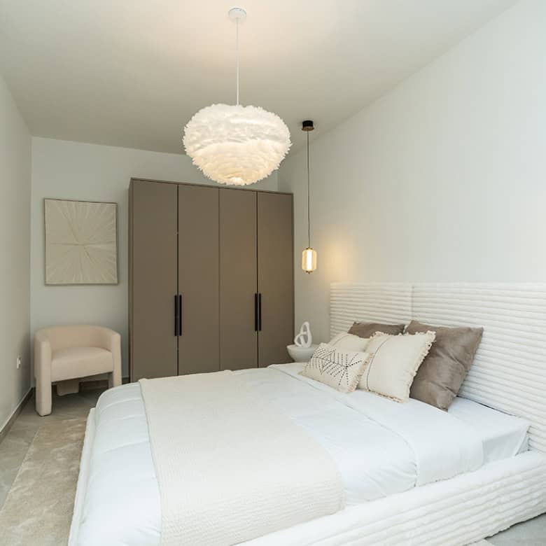 Spacious bedroom in a fully refurbished Marbella Golf Valley townhouse with contemporary decor.