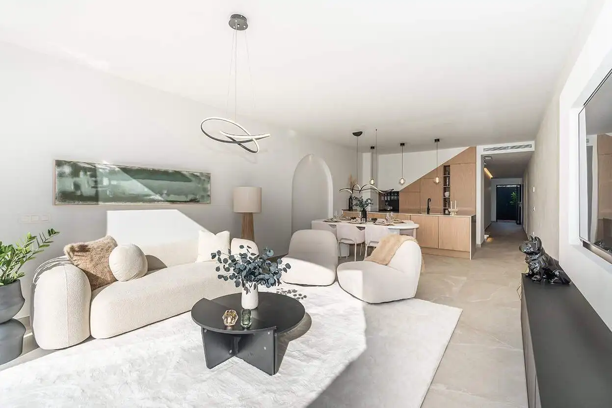 Spacious living area in a fully refurbished Marbella townhouse with contemporary decor and open-plan.