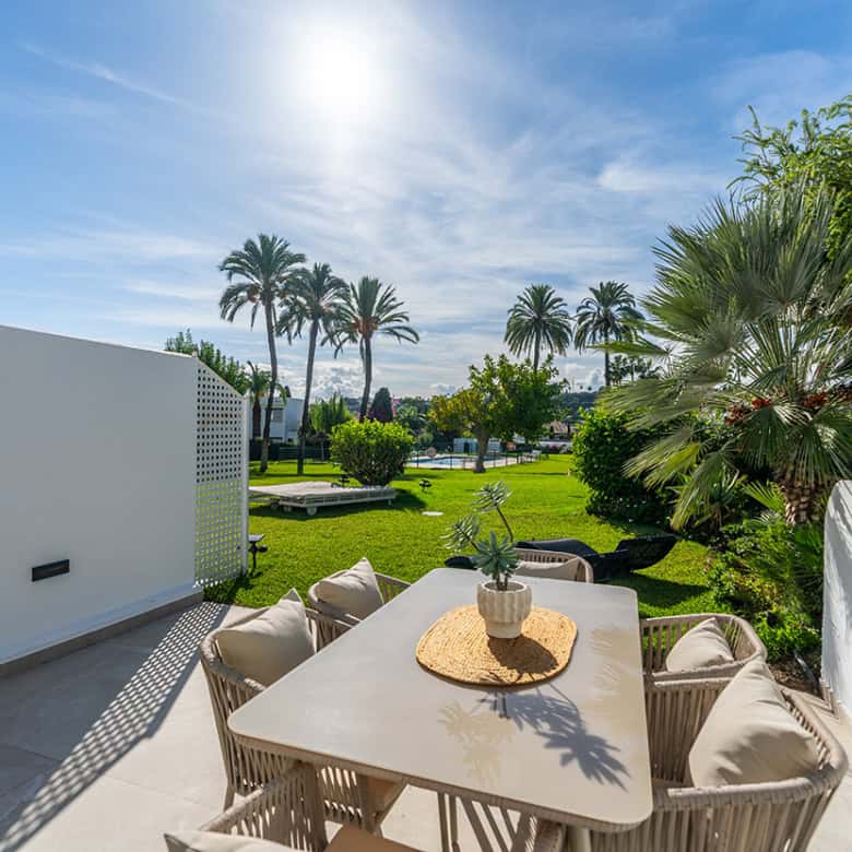 Spacious townhouse in Marbella Golf Valley featuring a large outdoor terrace and lush garden surroun.