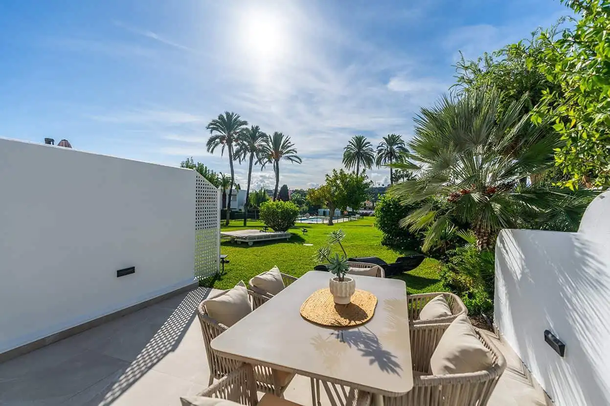 Spacious townhouse in Marbella Golf Valley featuring a large outdoor terrace and lush garden surroun.