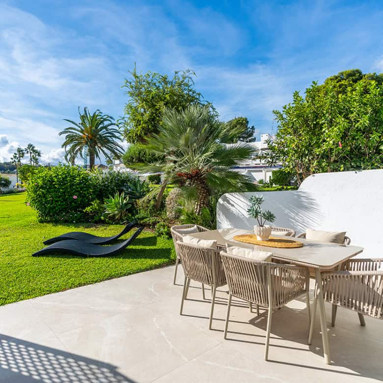 Spacious outdoor patio with lush greenery and seating in Marbella Golf Valley.