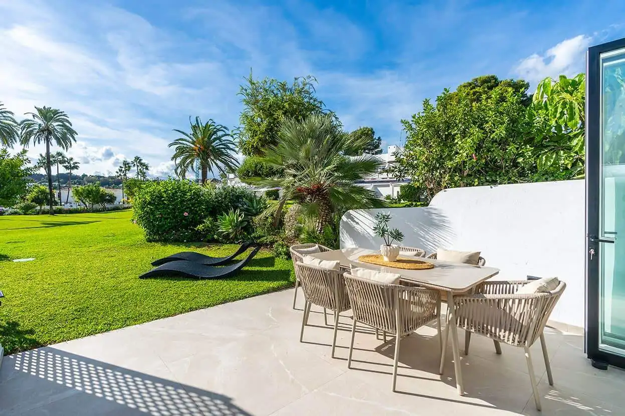 Spacious outdoor patio with lush greenery and seating in Marbella Golf Valley.